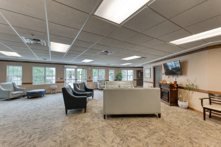 A spacious and modern living room with comfortable seating and ample natural light.