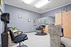 A modern hair salon interior with styling chairs and mirrors.