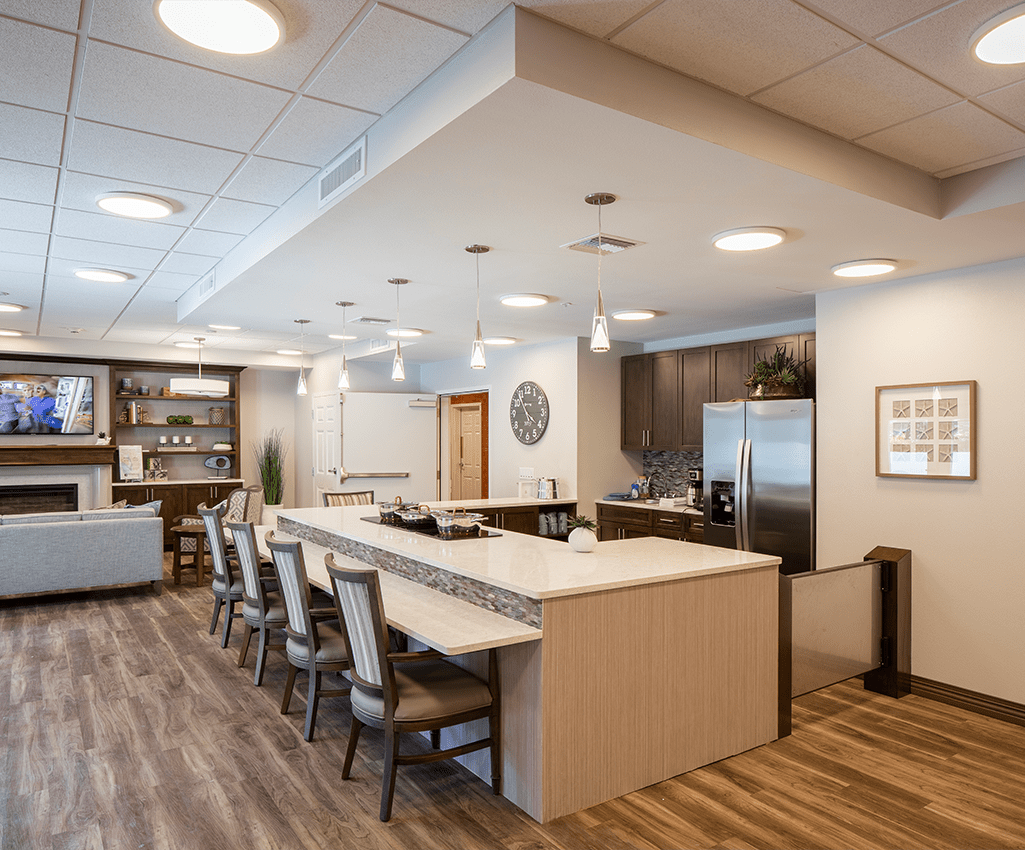 A modern kitchen and dining area featuring bar seating and elegant interior design.