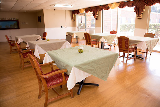 A bright and inviting dining area with neatly arranged tables and chairs.