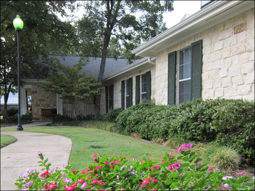 A charming house with a well-maintained garden featuring colorful flowers.