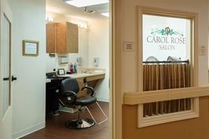 An interior view of a hair salon with a barber chair and salon equipment.