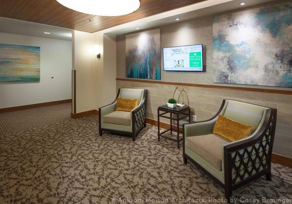 Modern waiting area with stylish chairs and artwork on the walls.