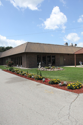 A well-maintained building surrounded by a vibrant garden.