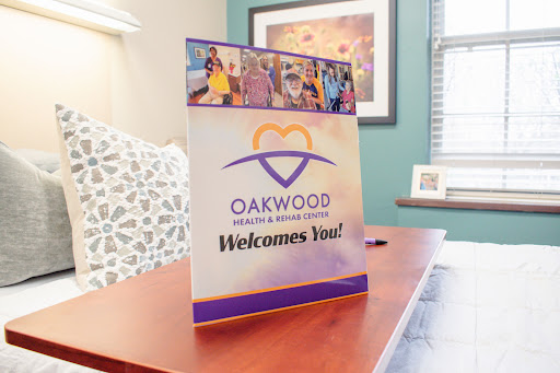 A welcoming sign displayed in a healthcare facility, promoting Oakwood's services.