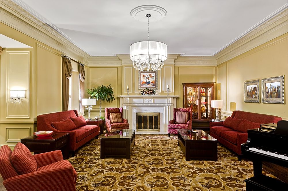 A luxurious classic living room with elegant furnishings and a chandelier.