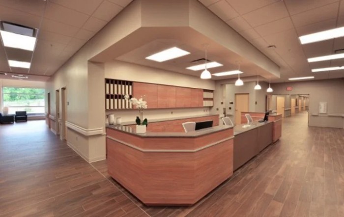 A modern office reception area with wooden furnishings and organized workspace.