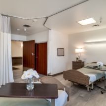 A hospital room with patient beds and medical equipment.