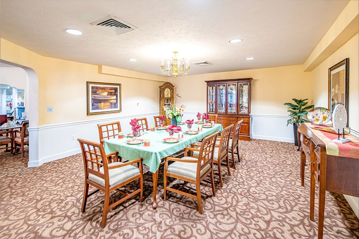 A well-decorated dining room with a table set for a meal.