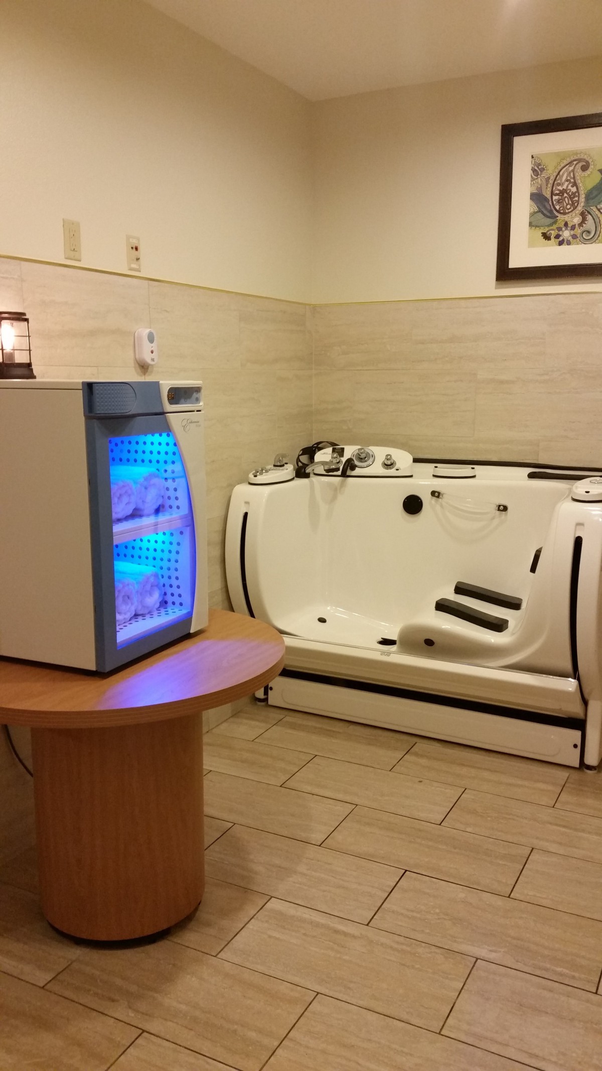 A serene spa room featuring a hydrotherapy bathtub and ambient lighting.
