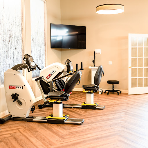 A well-equipped fitness area featuring exercise machines and a modern aesthetic.