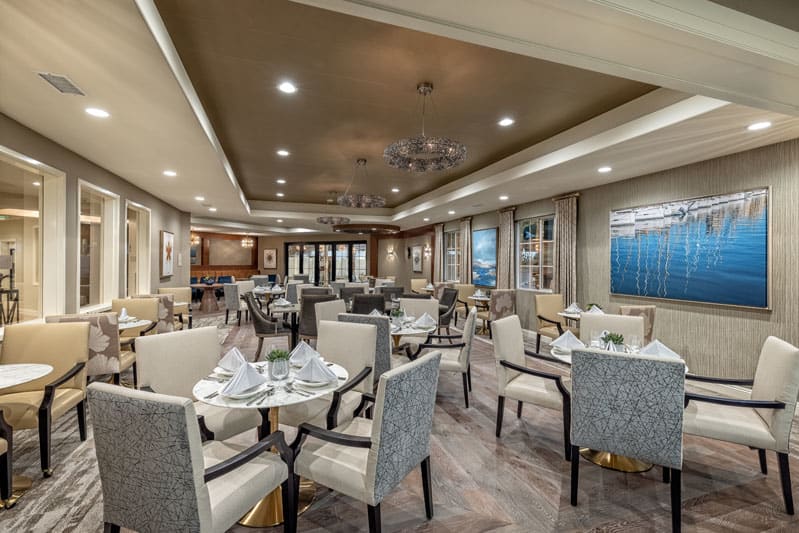 An elegant restaurant interior with neatly arranged tables and chairs.