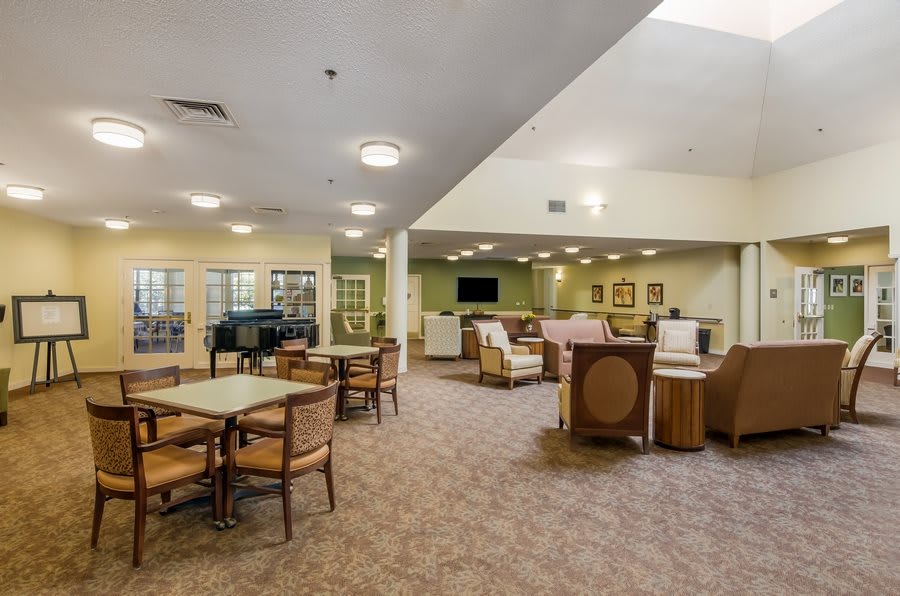 A spacious lounge area with ample seating and a television, designed for community gatherings.