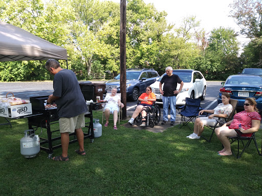 A relaxing summer barbecue gathering with friends enjoying food and conversation.