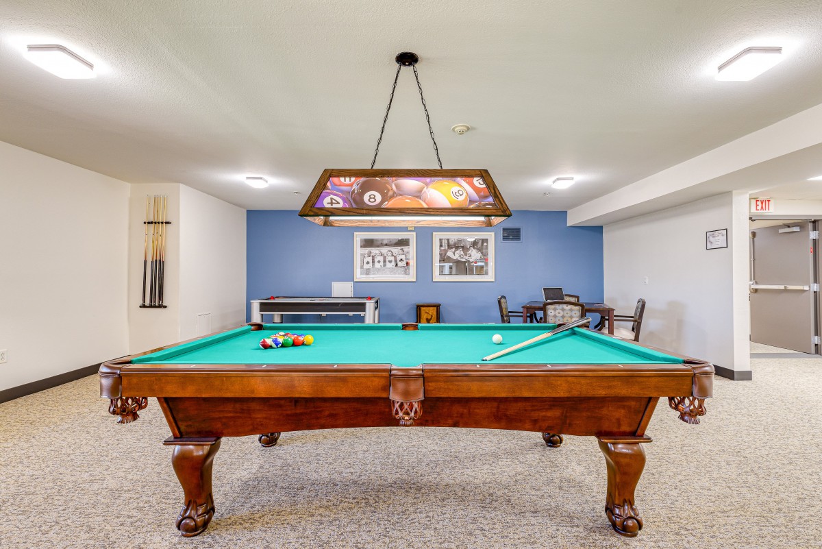 A cozy basement game room featuring a classic billiards table.