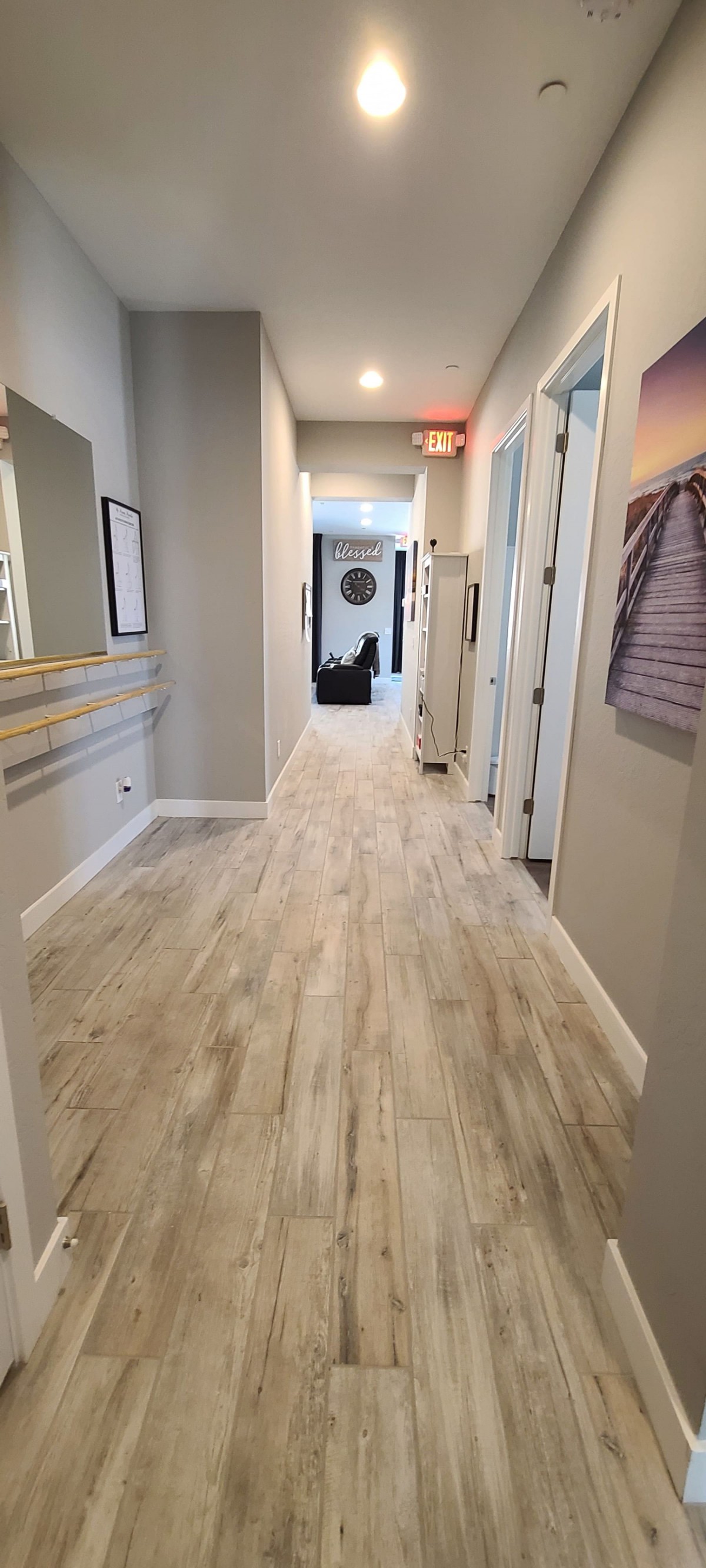 A modern indoor hallway with bright flooring and stylish decor.