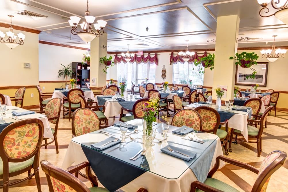 An elegant restaurant dining room with beautifully set tables and classic decor.