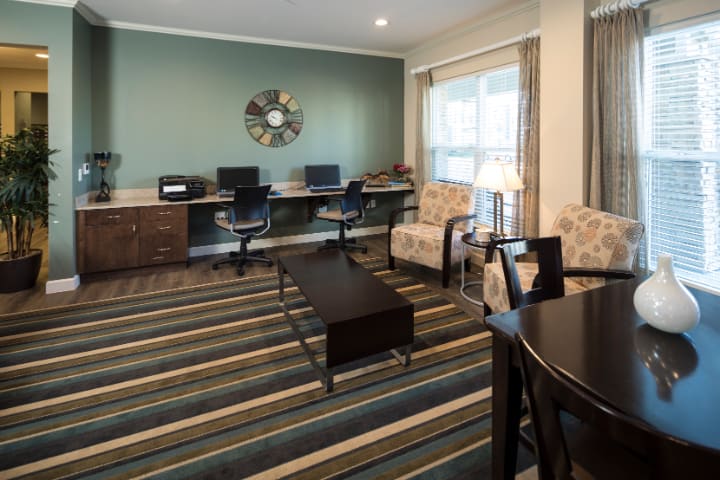 A cozy office space with multiple workstations and a seating area.