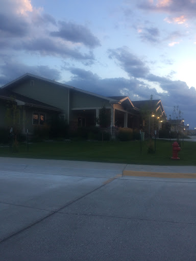 A quiet residential area captured during an evening with a cloudy sky.