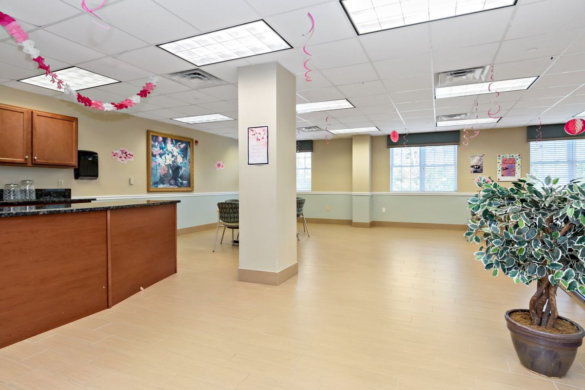 A spacious reception area with a counter and minimalist decorations.