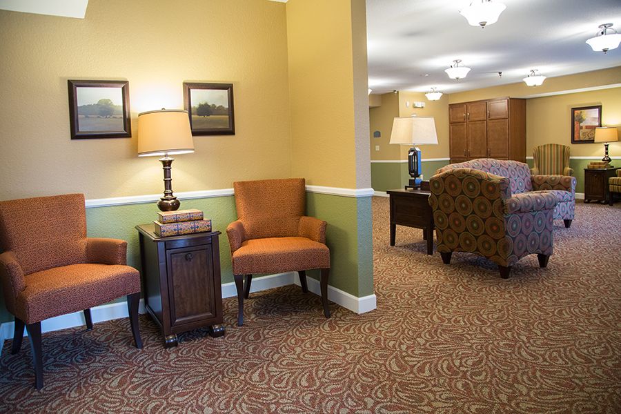 A cozy waiting area with comfortable chairs and warm lighting.