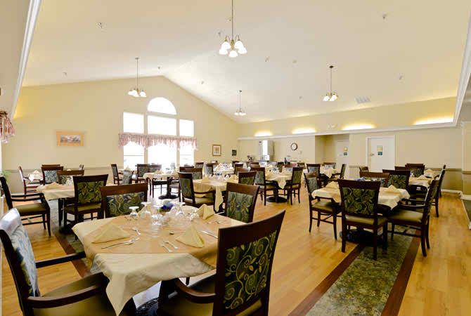 An elegantly set dining room with multiple tables and chairs, ready for guests.