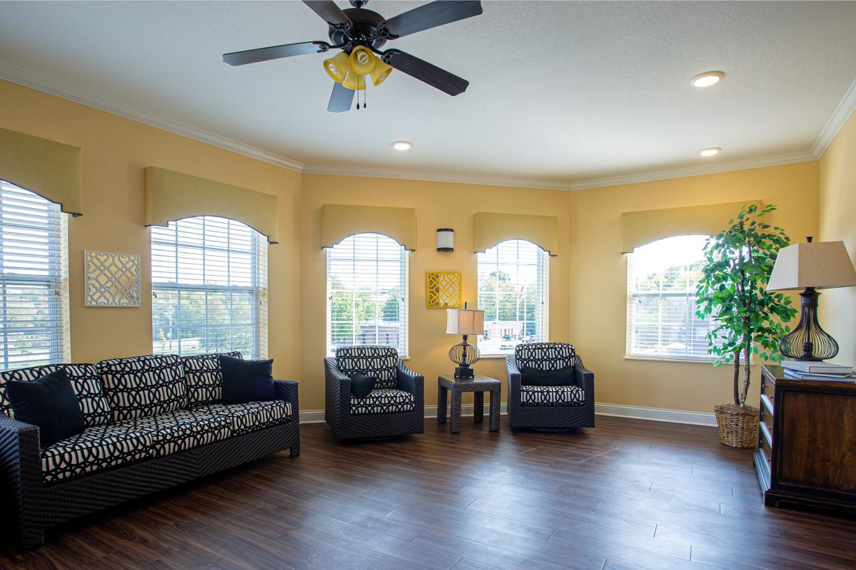 A bright living room with modern furniture and large windows.
