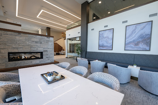 A sleek and modern living room featuring a stylish fireplace, elegant furniture, and contemporary artwork.