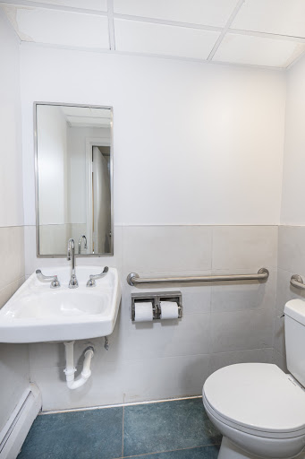 A modern and clean bathroom with a sink, toilet, and mirror.