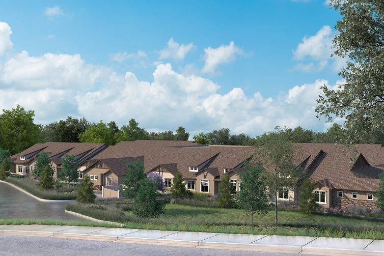 A row of suburban houses with well-maintained lawns and a clear blue sky.