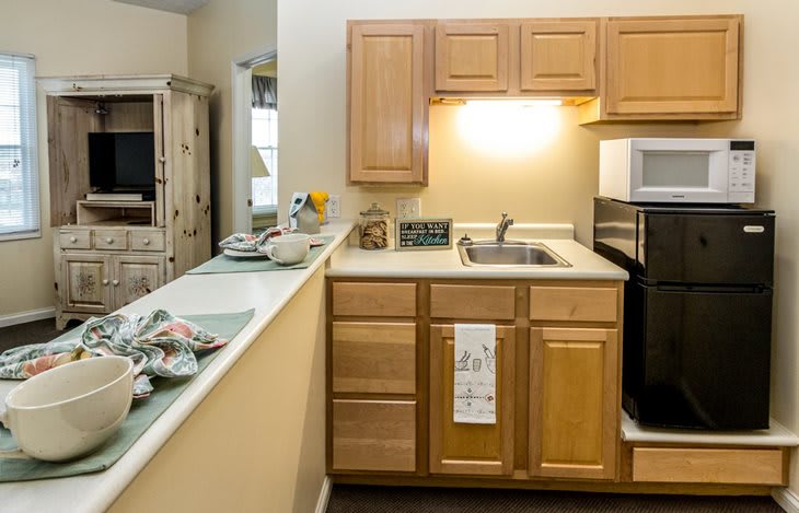 A modern kitchen with wooden cabinets, a sink, and built-in appliances.