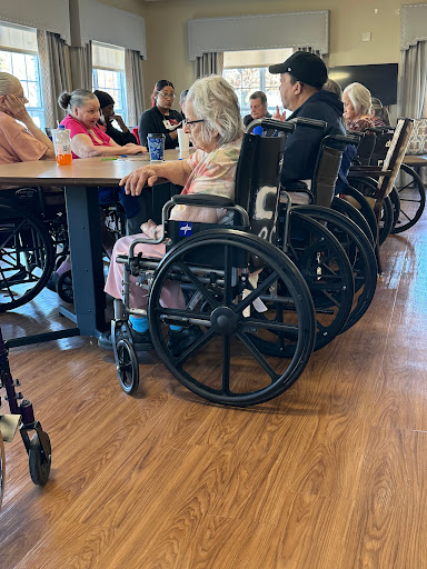 Residents of an assisted living facility participate in a group activity, showcasing community and companionship.