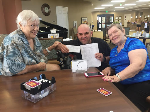 A joyful moment shared among friends, showcasing smiles and card games.