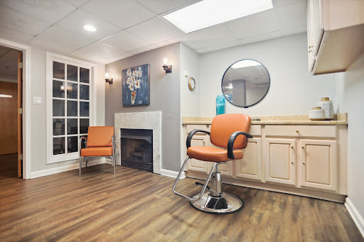 A stylish and modern barber shop featuring comfortable seating and a welcoming atmosphere.