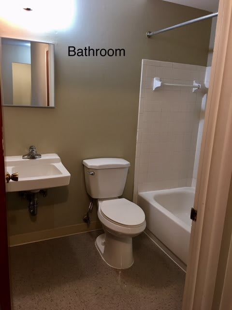 A small bathroom with a sink, toilet, and bathtub.