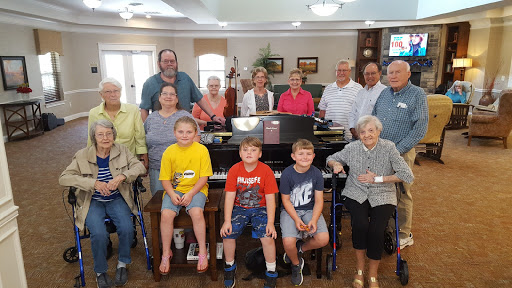 A joyful family gathering around the piano, capturing moments across generations.