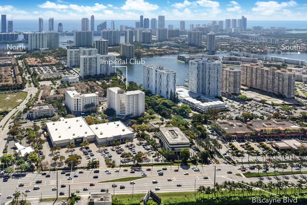 Aerial view of a bustling urban cityscape with high-rise buildings and busy roads.