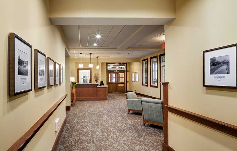 A well-lit office lobby with seating and a reception desk.