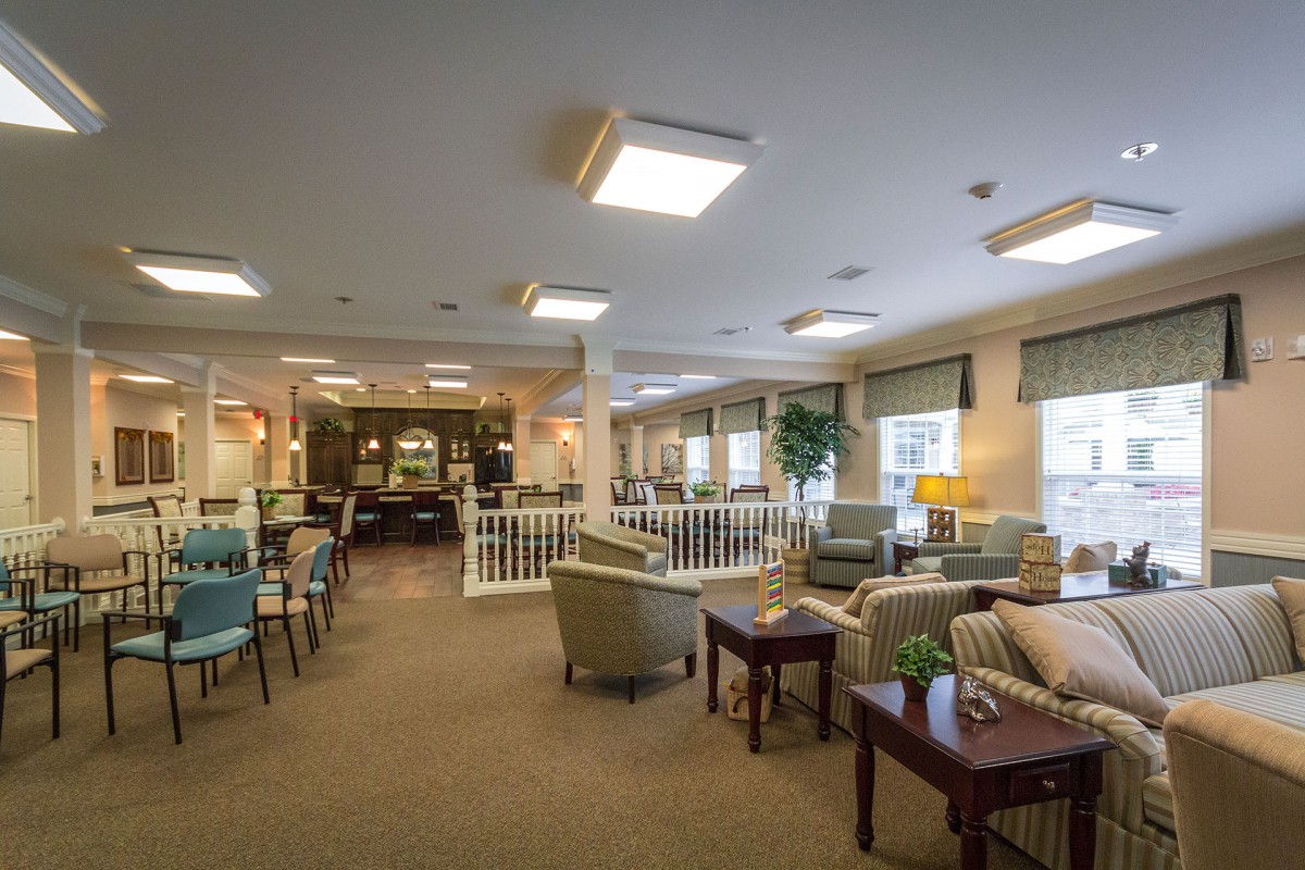A cozy communal living area with comfortable seating and soft lighting.