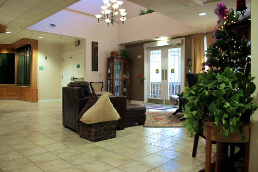 A welcoming lobby area featuring comfortable seating, decorative plants, and elegant lighting.