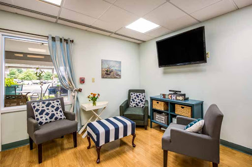 A cozy and modern waiting room with comfortable seating and decorative touches.
