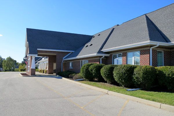 A modern building with a sloped roof and well-maintained landscaping.