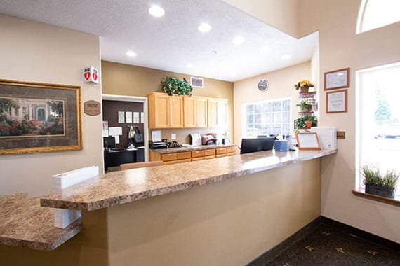 A view of a reception desk in an office setting with bright lighting.