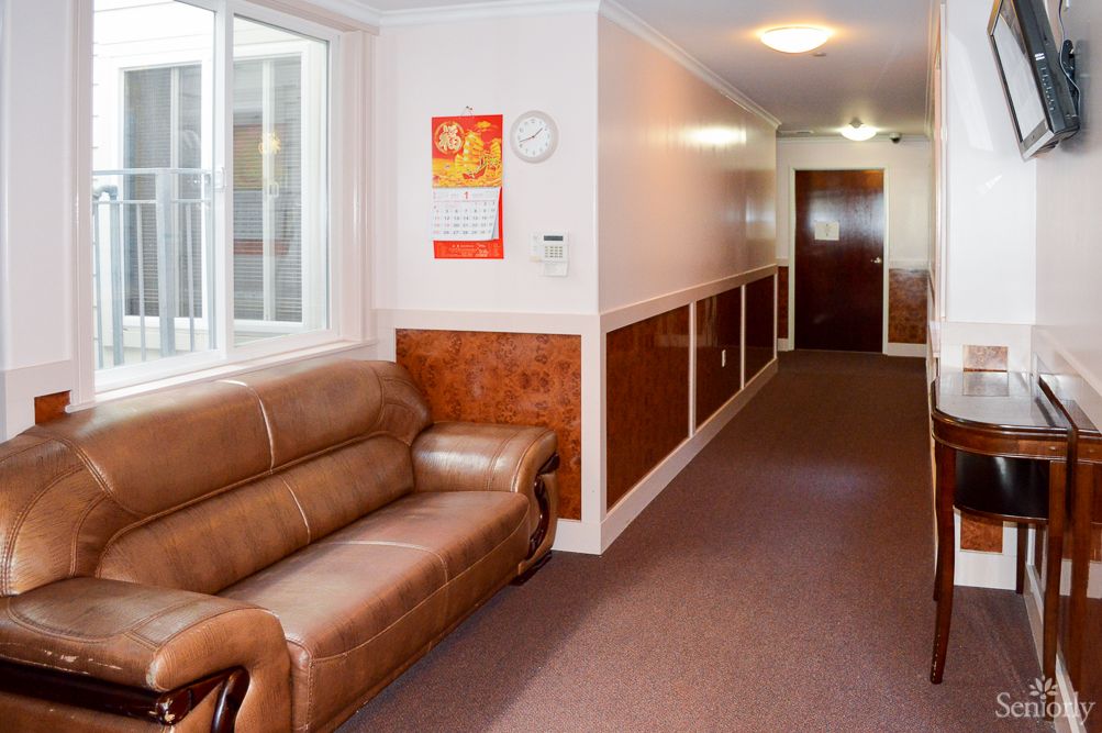 A cozy hallway with a leather sofa and artwork on the wall.