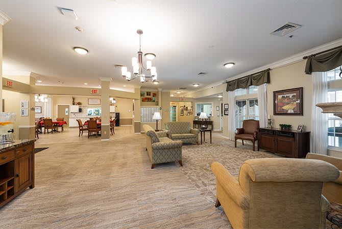 A spacious and cozy living room with comfortable seating and elegant lighting.