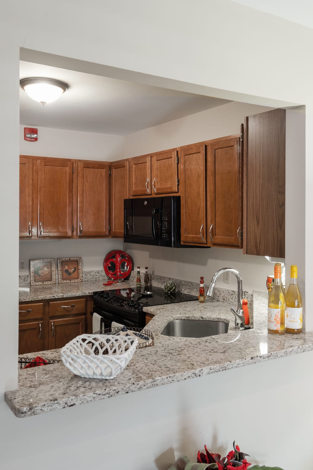 A modern kitchen with wood cabinets and granite countertops.