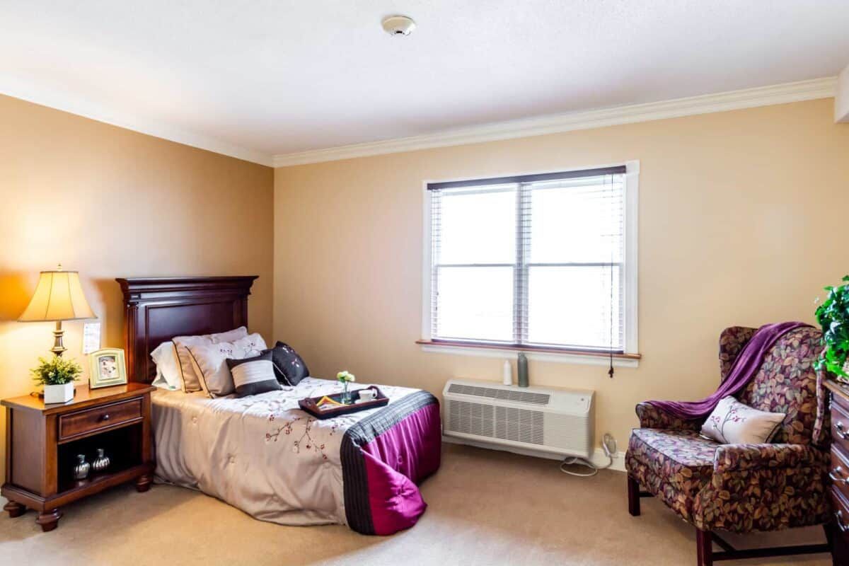 A cozy bedroom featuring a neatly made bed and elegant furnishings.