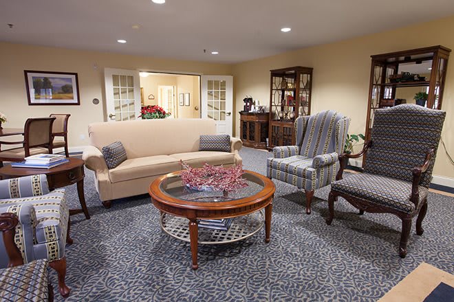 Cozy living room with a sofa, armchairs, and a coffee table.