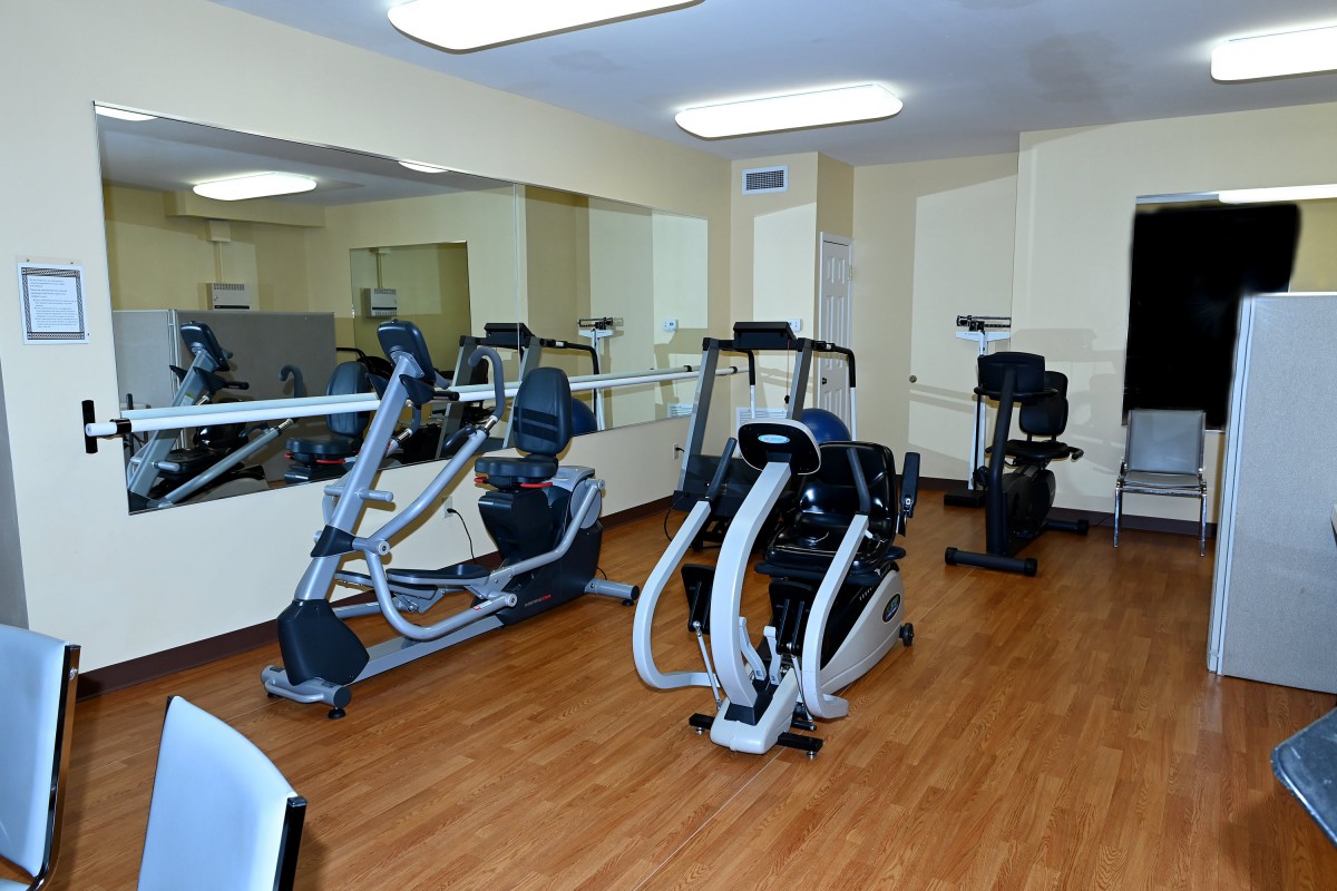 A gym with various exercise equipment including elliptical machines.