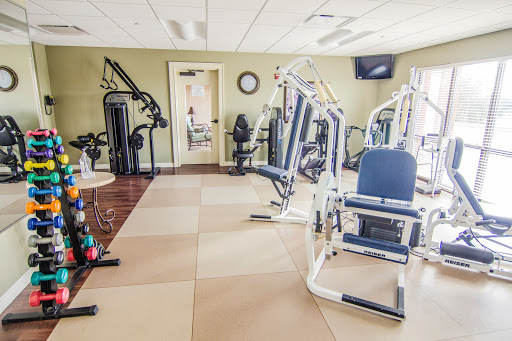 A well-equipped gym featuring various exercise machines for strength training.